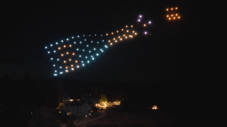Champagne bottle formed by drones above a wedding venue
